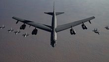 A B-52 heavy bomber, flanked by fighter jets, flies to the Middle East in a tacit threat to Iran on November 21, 2020