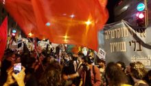 Hadash and Communist Party of Israel activists brandish red flags and Joint List banners during the mass protest held in Jerusalem against far-right Prime Minister Benjamin Netanyahu, Saturday night, March 20, 2021.