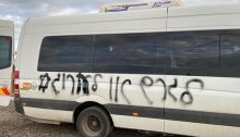 The Hebrew slogan "Expel or Kill" is spray-painted on a locally owned private bus in the Arab-Palestinian city of Kafr Qasim in central Israel, Thursday, March 25, 2021.