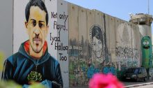 "Not only Floyd, Iyad Hallaq Too," a portrait of the 32-year-old autistic Palestinian man killed by Israeli police in occupied East Jerusalem in May 2020, rendered on Israel's "Apartheid Wall" separating Jerusalem and Bethlehem.