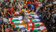 Thousands of Palestinians attend the funeral of the Abu Hatab family in Gaza City. Eight children and two women were killed in the three-store building in the Shati refugee camp, in the northern Gaza Strip, which collapsed following an Israeli airstrike, May 15, 2021.