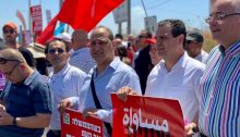 MK Ayman Odeh (second from right) during an anti-Netanyahu protest held at Kohav Yair Junction, May 14, 2021; the placard Odeh's holding reads "Equality."