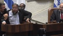 Racist MK Itamar Ben-Gvir is forcefully removed from the Knesset podium and then ejected from the plenum after calling Joint List MK Ahmed Tibi (right) a "terrorist", July 26, 2021.