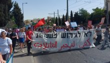 Demonstrators protest the pending eviction of Palestinian families from their homes in the neighborhood of Sheikh Jarrah in occupied East Jerusalem, June 11, 2021. The large banner reads "NO to the eviction of families."